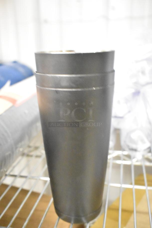 Set of 12 metal mixing cups, shown on a wire shelf. Cups appear in good condition, ideal for beverages or mixing.