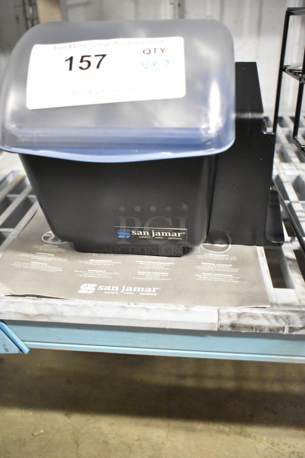 San Jamar poly topping rail with black stand and included roll of material, in used condition. Auction tag shows lot number 157.