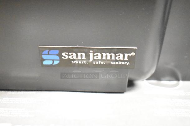 San Jamar poly topping rail with brand logo, black stand, and roll of material. "Smart. Safe. Sanitary" tagline visible.