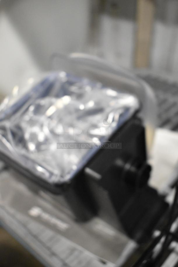 Blurry image showing San Jamar Poly Topping Rail and black stand, with a roll of material, suggesting a set of mixed items.