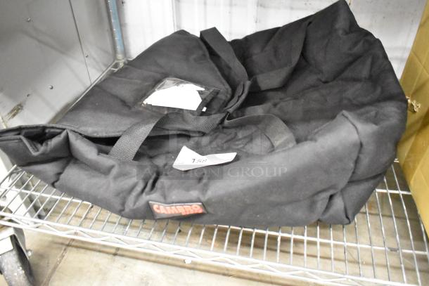 Cambro black insulated food carrying bag, visibly labeled, placed on a wire shelf. Appears in good condition.