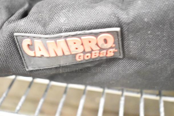 Cambro GoBag black insulated food carrying bag, visible label, part of a lot with white poly bin and Hobart 20 qt bowl.