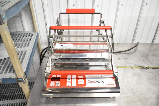 Brand new Pavoni CookMatic tartlet machine, stainless steel, 110V, 1 Phase, with minor scratches, model visible on panel.