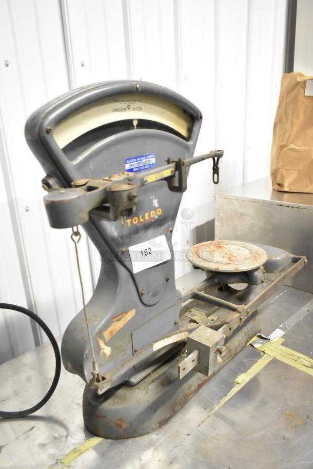 Toledo 3420 countertop metal bakery scale, gray, vintage, with visible rust and wear, branded markings, model 3420.
