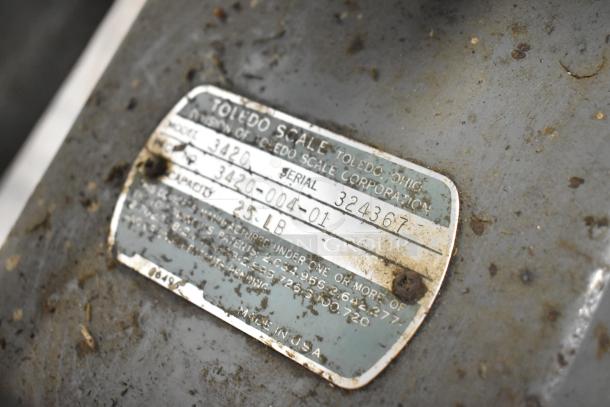 Toledo 3420 countertop metal bakery scale with label showing model, serial number 324367, and 25 lb capacity. Worn condition.