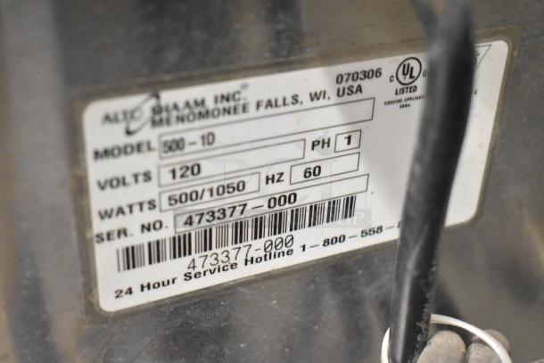 Alto Shaam 500-1D stainless steel warming drawer label showing model, voltage, and serial number details.