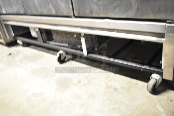 True T-72F stainless steel commercial 3-door reach-in freezer with poly-coated racks on casters, 115V, 1 phase.