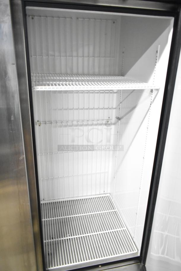 True T-72F stainless steel commercial 3-door reach-in freezer with poly-coated racks, on casters, 115V, 1 phase.