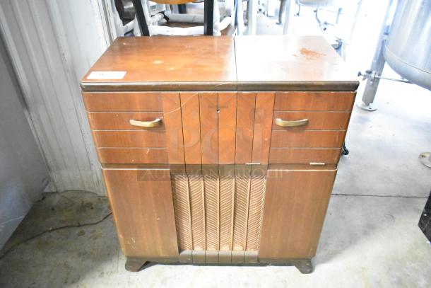 Victrola RCA Victor 67V1 wood-pattern counter with built-in record player. Features brass handles, showing wear and scratches.