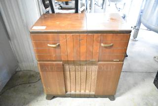 Victrola RCA Victor 67V1 wood-pattern counter with built-in record player. Features brass handles, showing wear and scratches.
