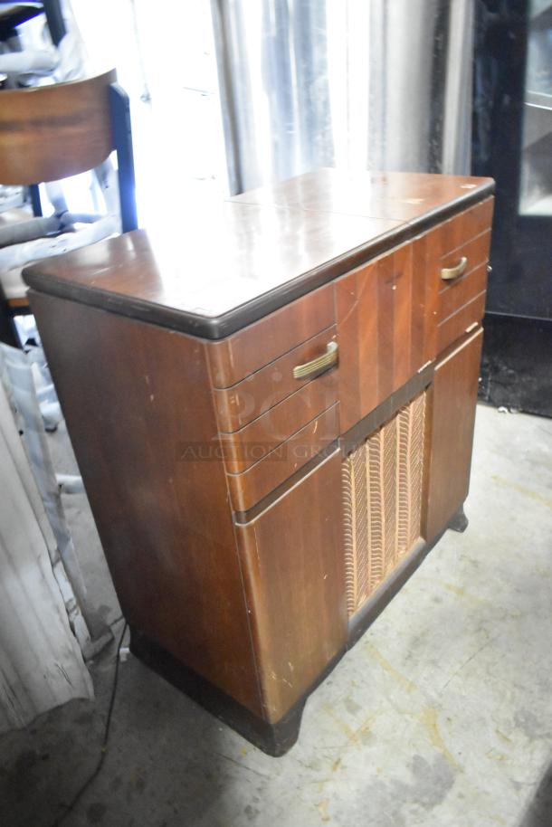 Victrola RCA Victor 67V1 wood-patterned counter with built-in record player, vintage design, moderate wear, brass handles.