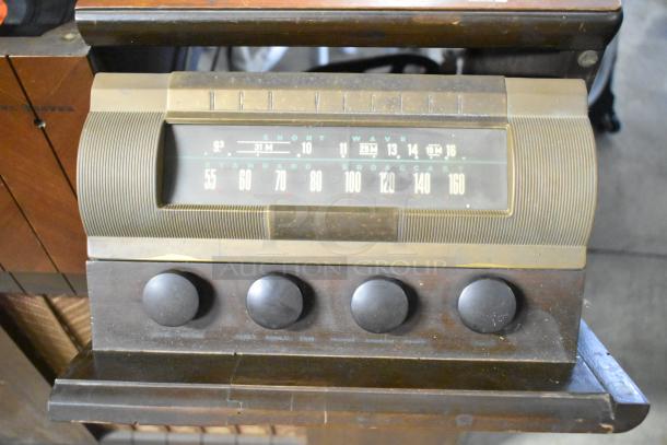 Victrola RCA Victor 67V1, wood-pattern counter with record player, integrated radio, vintage dials, well-used condition.