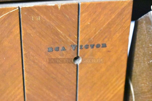 Victrola RCA Victor 67V1 wood-patterned counter, featuring "RCA Victor" label; vintage record player included.