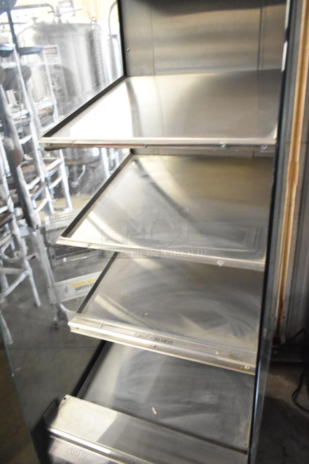 BKI HSS2-4T metal commercial hot merchandiser with four shelves, commercial casters, 208V, 1 phase, excellent condition.