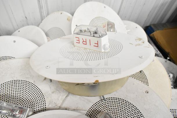 26 white ceiling speakers with integrated fire alarm lights, "FIRE" label visible, used condition, auctioned as lot.