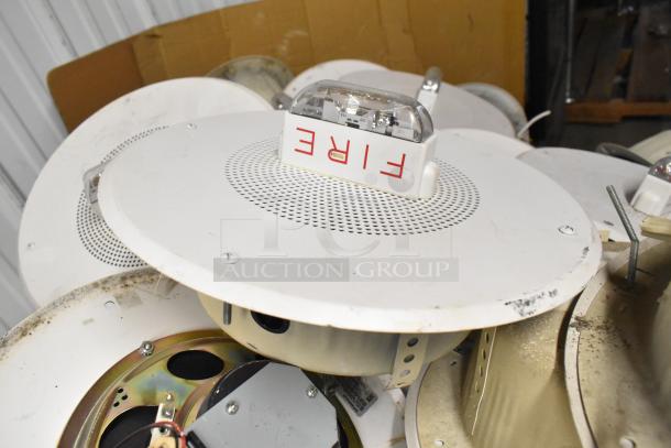 65 Wheelock CBB-8 speakers with fire alarm lights, visible wear, "FIRE" label, duct ceiling mounts. Auction for bulk lot.