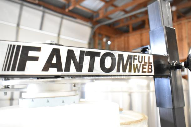 Fantom Full Web Manual Stretch Wrapper, featuring black lettering on a steel frame. Ideal for industrial packaging tasks.