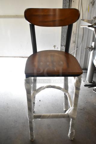Wooden bar-height chair with a black metal frame, wrapped for protection. Scratch and dent condition, brand new.