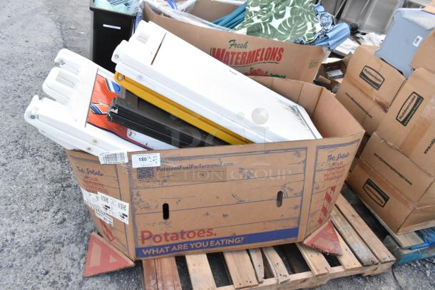Six A-frame sidewalk signs in a cardboard box on a pallet, various colors, used condition. Box labeled "Potatoes."
