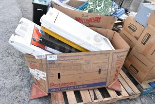 Six A-frame sidewalk signs in a cardboard box on a pallet, various colors, used condition. Box labeled "Potatoes."