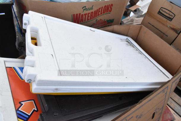 Six white A-frame sidewalk signs stacked together, some wear visible, handle cutouts, includes various designs.