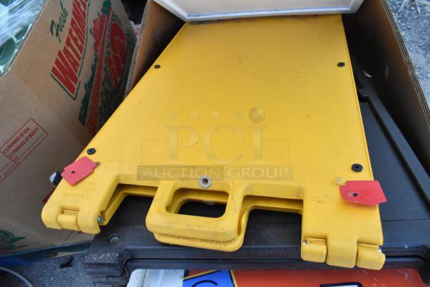 Yellow A-frame sidewalk sign stack with carrying handle, minor wear visible. Includes 6 signs, enhancing bid value 6x.