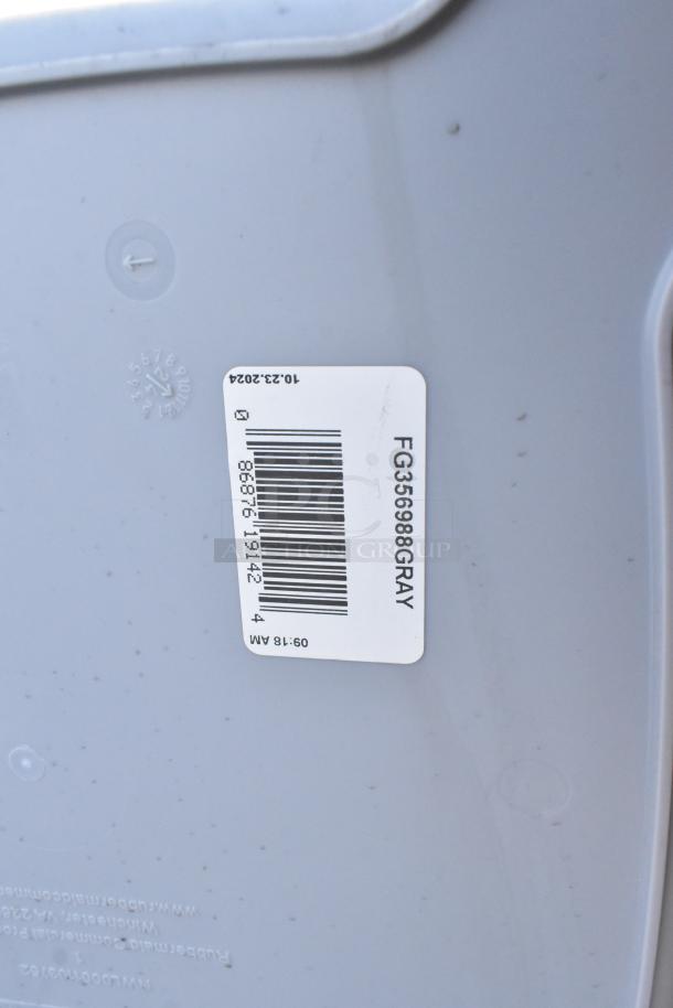 Gray Rubbermaid FG356988 Untouchable 92 Qt. trash can, brand new with some scratches and dents, label visible. 