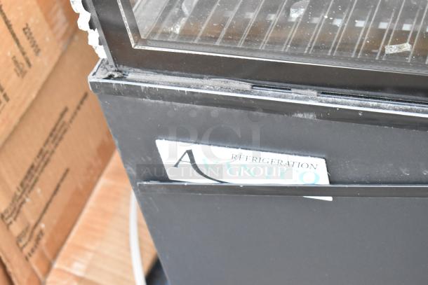 Avantco 193BC72HCB 72" black refrigerated bakery case with scratched and broken curved glass, model label visible.