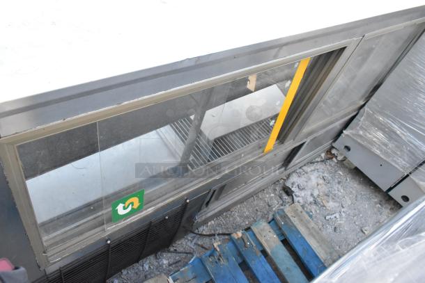 Leader Metal Commercial Floor Deli Display Case Merchandiser, glass front, metal shelving, used condition, visible scuffs.