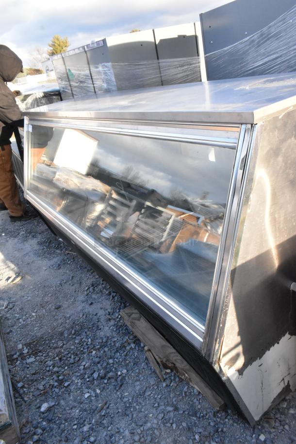 Leader metal commercial deli display case, floor-style, stainless steel with glass front, used condition, outside storage.