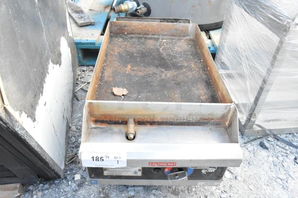 Star stainless steel commercial gas griddle, countertop model, showing signs of rust and wear, with visible control knobs and caution label.