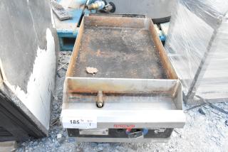 Star stainless steel commercial gas griddle, countertop model, showing signs of rust and wear, with visible control knobs and caution label.