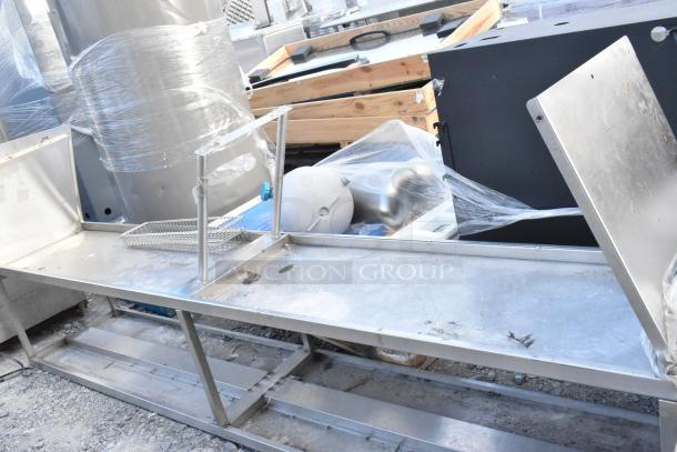 Stainless steel 2-tier over shelf, used condition, visible wear, suitable for kitchen or storage, sturdy construction.