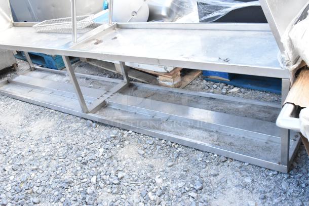 Stainless steel 2-tier over shelf, used condition, sturdy frame, ideal for kitchen storage, visible wear on surfaces.