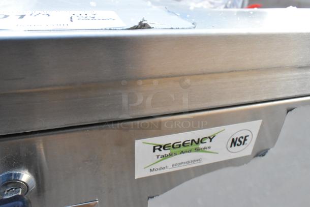 Brand new Regency 600PHS30HC single bowl portable hand sink cart, scratch and dent condition, NSF certified label visible.