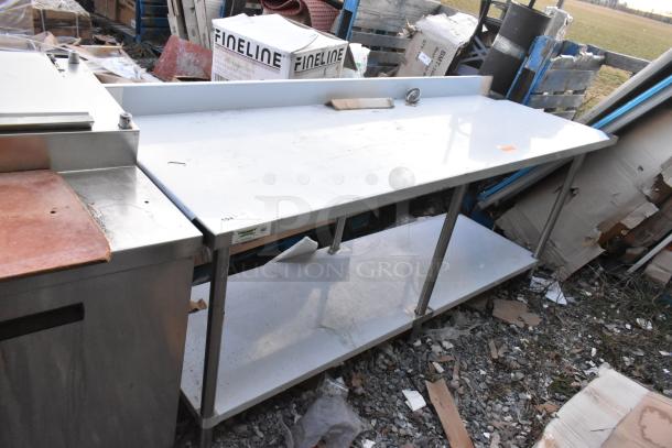 Regency 600TSB3084S stainless steel commercial table with metal under shelf, featuring minor surface wear, ideal for kitchens.