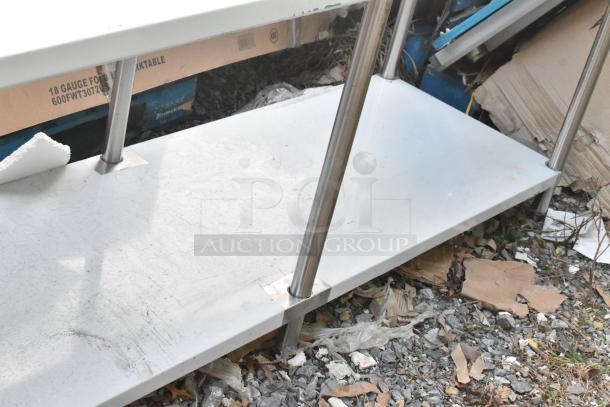 Regency 600TSB3084S stainless steel table with metal under shelf. Shows cosmetic wear. Ideal for commercial use.