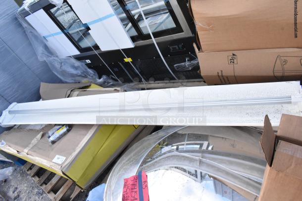 Alt text: Mixed lot with patio umbrellas, mirrors, and more. Some items in original packaging. Scratches visible on surfaces.