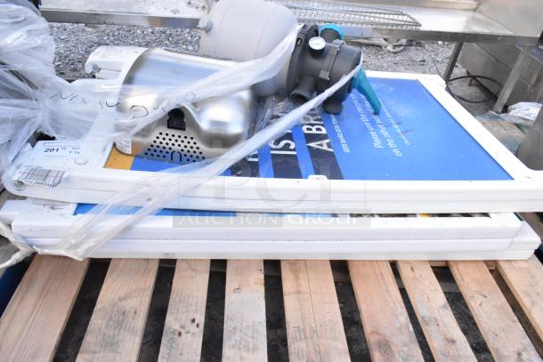 Five mixed items including A-frame sidewalk signs and an Xcelerator hand dryer, bundled and wrapped in plastic, placed on a pallet.