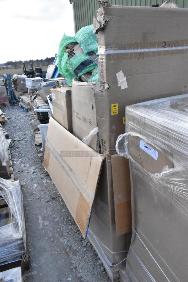 Brand new scratch and dent items, including ice bin and work table, in damaged packaging on pallets. Labels include "B143."