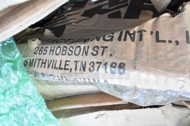 Box showing address "265 Hobson St, Smithville, TN 37166" with visible packaging and bubble wrap. Scratch and dent items inside.