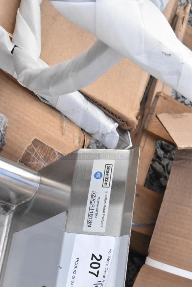 Brand new Steelton 522CS11818N single bay stainless steel sink, no legs. Scratch and dent, NSF label visible.