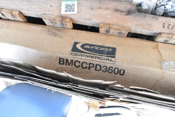 Cardboard box with Suncast Commercial BMCCPD3600 label, indicating a heavy-duty 3-shelf storage cabinet inside, brand new condition.