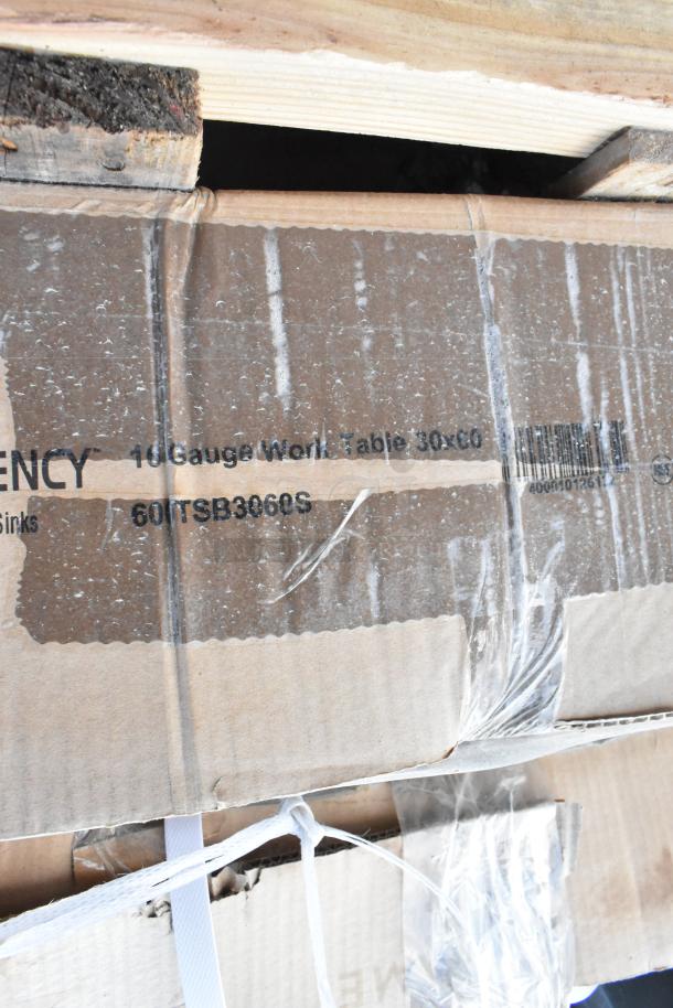 Cardboard packaging marked "10 Gauge Work Table 30x60" in new condition, showing strapping and protective wrapping.