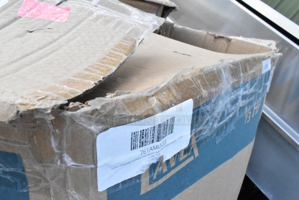 Damaged cardboard box with barcode label reading "Lave 3-Speed Compact Air Mover." Box shows signs of wear.