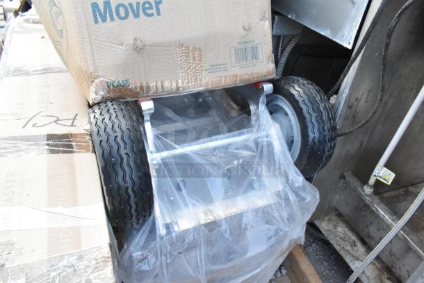 7 brand new scratch and dent items, featuring a hand truck with visible packaging and durable wheels; includes work table and air mover.