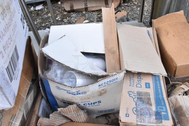 Boxes of AmerCare Royal cups and Scott folded towel dispensers in scratch and dent condition.