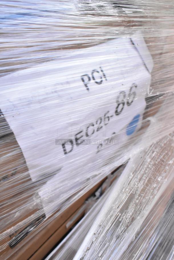 Pallet wrapped items with visible label "PCI DEC26-806." Includes new scratch and dent furniture parts.