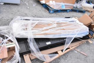 Brand new black metal locker system with minor scratches and dents, wrapped in protective plastic on a pallet.