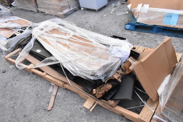 Brand new black metal locker system, scratch and dent condition, wrapped in plastic on a wooden pallet, includes packaging materials.